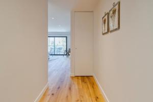 an empty room with white walls and wooden floors at Quinta View Apartment, By Home Match in Setúbal +15 photos