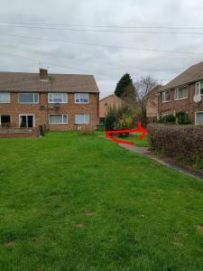 a house with a red arrow in a yard at Dana's room - free wifi & parking in Skellingthorpe