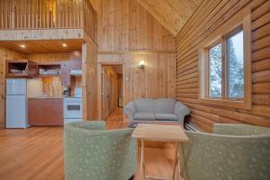 a living room with a table and chairs in a cabin at Chalet Aigle 7 min to SPA for 16 Guests , Skiing in Saint-Paul-de-Montminy