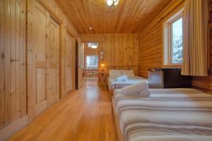 a room with three beds in a wooden cabin at Chalet Aigle 7 min to SPA for 16 Guests , Skiing in Saint-Paul-de-Montminy