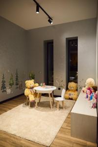 two teddy bears sitting around a table in a room at Monte Blu in Migovo