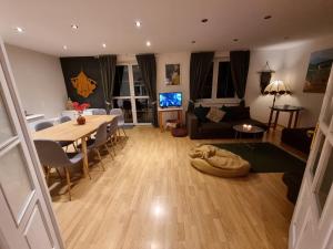 a living room with a table and a dining room at Szczyt Wszystkiego in Szczyrk