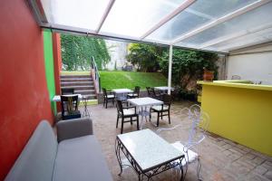 an outdoor patio with tables and chairs at Vilaró Art Wine Hotel in Buenos Aires