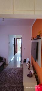 a living room with a couch and a table at Apartamento Centro à 100 metros da Praça da Matriz in Boituva