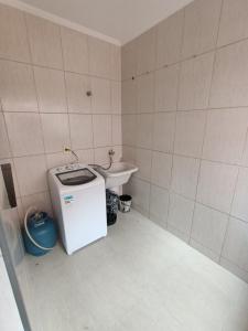 a small bathroom with a sink and a small refrigerator at Apartamento Centro à 100 metros da Praça da Matriz in Boituva +19 photos