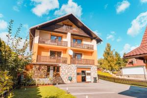 a building with balconies on the side of it at Apartmán Otília in Ždiar