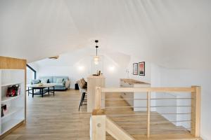 a kitchen and living room with a staircase in a house at BlueApart Jeżynowa Jastarnia in Jastarnia