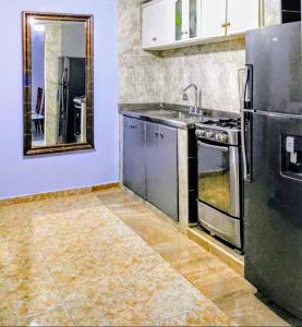 a kitchen with a sink and a stove at Casa Del Pintor in Santa Marta +18 photos