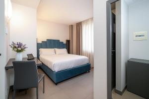 Una cama o camas en una habitación de Hotiday Napoli Porto