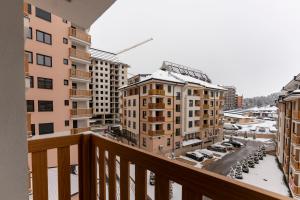 a balcony with a view of a parking lot and buildings at Lux apartman 40 in Zlatibor