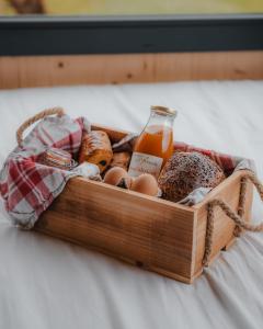 una cassa di pane e uova e una bottiglia di succo di Parcel Tiny House I Pommiers a Landes-sur-Ajon