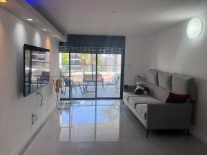 a living room with a couch and a table at Ashdod big 5 Rooms for 10 people in Ashdod
