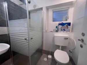 a bathroom with a shower and a toilet and a sink at Ashdod big 5 Rooms for 10 people in Ashdod