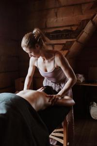 a woman sitting on a bed with a man at Deluxe Vintage Chic Apartment - Kazimierz Old Town in Kraków +27 photos