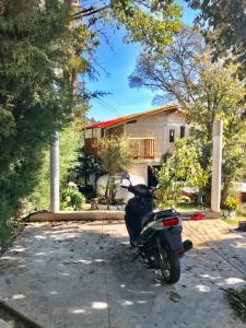 a motorcycle parked in front of a house at Cabaña de descanso en Tlazala in Cedro +9 photos