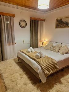 a bedroom with a large bed with towels on it at Pindus Nest in Metsovo