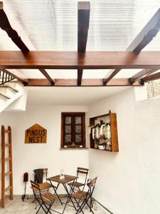 a room with a table and chairs and a ceiling at Pindus Nest in Metsovo +19 photos