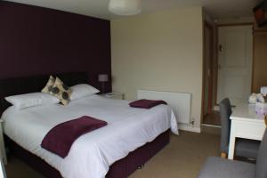a bedroom with a large white bed with two pillows at Premier Room in Kelso