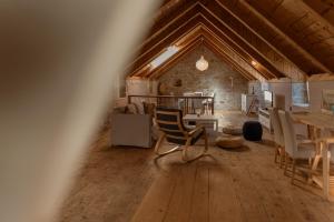 a room with a table and chairs in a building at Stone house Olsavinia close to the beach in Kaštela