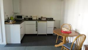 a kitchen with a table and a small table with chairs at Premier Room in Kelso