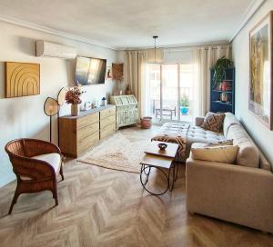 a living room with a couch and a table at Light Blue Apartment Orihuela Costa in Orihuela Costa
