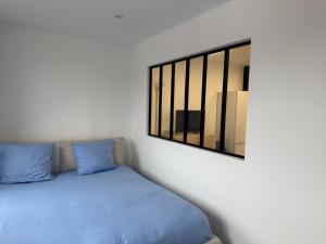 Ένα ή περισσότερα κρεβάτια σε δωμάτιο στο Le Prestige - T2 Neuf et Equipé