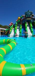 a water slide in a pool with people on it at Studio port santa lucia in Saint-Raphaël