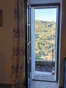 an open door to a window with a view at La Dimora di Dida in Seggiano