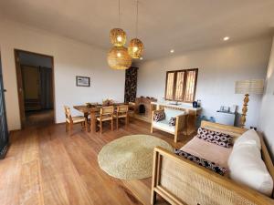 a living room with a couch and a table at Hondo Hondo mountain view in Lushoto +27 photos