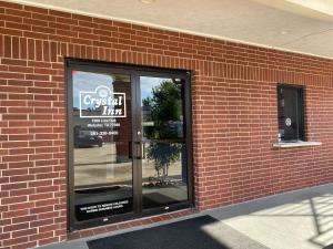 a brick building with a sign in the window at Crystal Inn - NASA Webster in Webster +4 photos