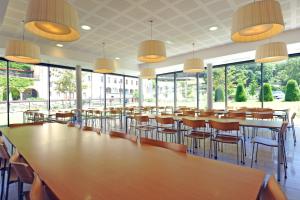 圣沙蒙L Hermitage的一间有桌椅和窗户的大房间