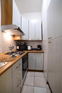 a kitchen with white cabinets and a stove top oven at A Due Passi dal Popolo in Ascoli Piceno