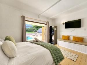 a bedroom with a large bed and a television at 70 on Brander in Cape Town
