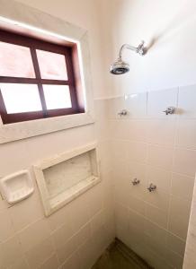 a bathroom with a window and a shower at Oásis House in Macau +34 photos