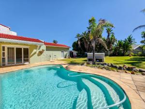 a swimming pool in front of a house at 70 on Brander in Cape Town