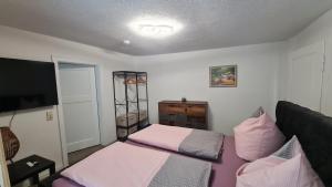 a living room with a bed and a tv at Ferienwohnung Hugos Altstadt in Pirna