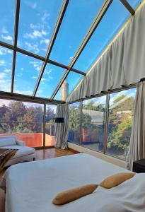 a room with two beds and a large window at Hotel Boutique Casa de Campo Potrero de los Funes a 30min in Estancia Grande