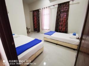 Ένα ή περισσότερα κρεβάτια σε δωμάτιο στο Melur Guesthouse