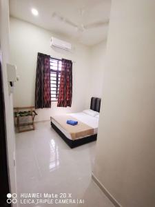 Ένα ή περισσότερα κρεβάτια σε δωμάτιο στο Melur Guesthouse +3 φωτογραφίες