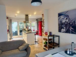 a living room with a couch and a kitchen at 4 bed Townhouse with spectacular views 4 miles from Cardiff 10min drive or train journey to city centre in Cardiff