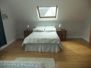 a bedroom with a bed and a window in it at Daleview Apartment in Manorcunningham