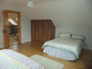 a bedroom with two beds and a sliding glass door at Daleview Apartment in Manorcunningham