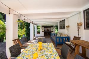 a dining room with a table and chairs at Sunny Poolside Escape in Somerset West in Somerset West