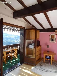 a room with a table and a dining room at Mon petit coin de paradis in Saint-Gervais-les-Bains