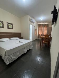 Ένα ή περισσότερα κρεβάτια σε δωμάτιο στο Hotel Pousada Figueiredo