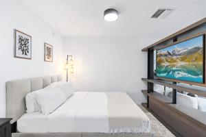 a bedroom with a bed and a flat screen tv at High-Rise Luxury Condo in Downtown Miami in Miami