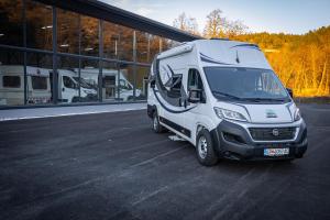 a white van parked in front of a building at Gogo vans home on wheels in Kriva Palanka +14 photos