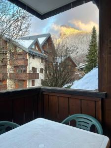 a view from a balcony with a table and chairs at Samoëns à Pied – Appt 4 pers in Samoëns
