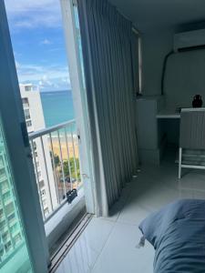 een slaapkamer met een balkon met uitzicht op de oceaan bij Isla Verde Beach Dreamscape in San Juan
