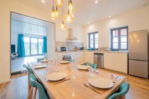a kitchen and dining room with a table and chairs at The Gingerbread Spa - Private Parking - Terrace in Gertwiller